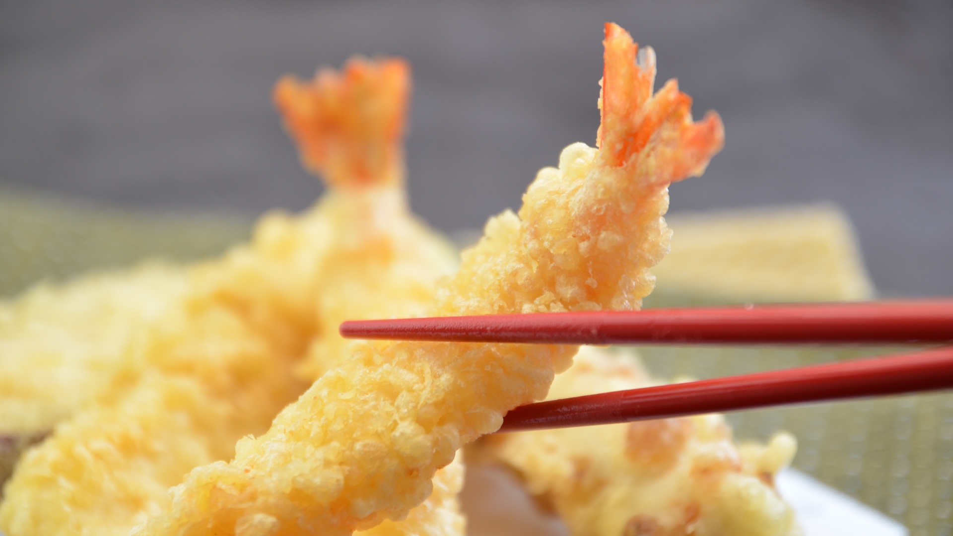 Lifting a tempura shrimp with a chopstick